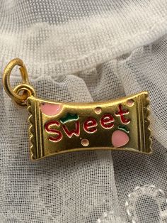 SUPER SWEET CHARM! This cute little charm or pendant would be great for a charm necklace! Fun strawberry candy charm! Both sides designed.  New and unworn. Matte gold tone with enamel. Jump ring included. Please refer to pic with ruler for measurements in inches. Cheap Retro Necklaces With Vintage Charm, Cute Gold Charms For Gifts, Cute Pendant Charms For Gifts, Cute Charms With Lobster Clasp For Gift, Cute Nickel-free Charms For Gifts, Personalized Cute Charms For Birthday, Cute Personalized Birthday Charms, Cute Charm Necklaces For Birthday, Sweet Pink Charm Necklace For Gift