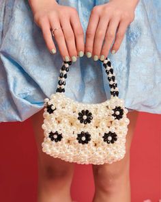 white beaded mini purse with black beaded flowers Elegant Spring Beaded Shoulder Bag, Spring Beaded Bag Gift, Spring Beaded Bag As Gift, Spring Beaded Bags As Gifts, Spring Beaded Bags Perfect For Gifts, Handheld Beaded Bags For Spring, Elegant Beaded Bags For Spring, Chic Embellished Bags For Spring, Pearl Beaded Bag