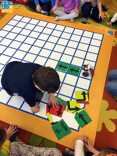 a group of children sitting on the floor playing with puzzles