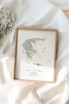 a white sheet with flowers and a framed map