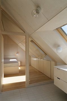 an attic bedroom with white tile flooring and wooden walls