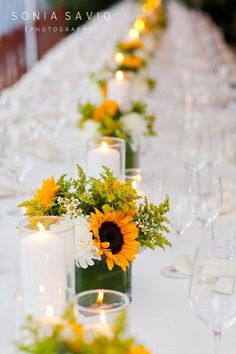 a long table with candles and flowers on it