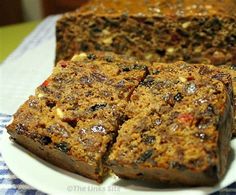 there are several pieces of fruit cake on the plate and one slice has been cut