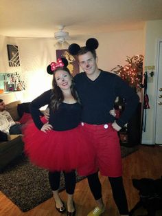 a man and woman in mickey mouse costumes