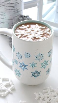 a cup of hot chocolate with marshmallows on the side