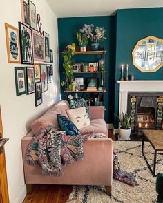 a living room filled with furniture and lots of pictures on the wall next to a fire place