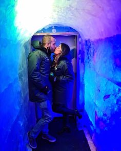 a man and woman kissing in an ice cave