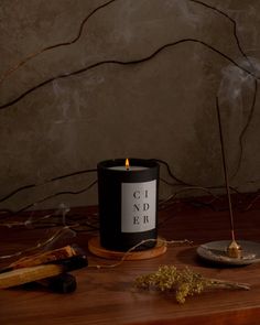 Like a crackling fire in a cozy cabin, smoky notes of woodsmoke, incense, and cedar embers meld together to form a blanket of aroma, enveloping you in its warmth. Made in Brooklyn, New York with 100% soy wax for an eco-friendly clean burn. We use lead-free cotton wicks and premium fragrance oils infused with essential oils. Our candles are vegan, cruelty-free, phthalate-free, and petroleum-free. Dark Candle Aesthetic, Candle Photoshoot, Candle Board, Monochrome Aesthetic, Brooklyn Candle Studio, Candles Dark, Candles Photography, Candle Studio, Candle Glow