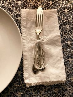 a white plate with silverware on top of it