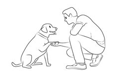 a man kneeling down petting a dog with his hand on it's paw