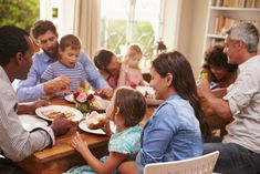 a group of people sitting around a table eating food