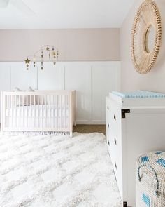 a baby's room with a crib and dresser