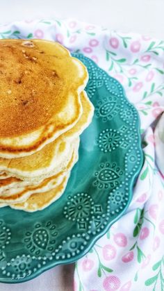 a stack of pancakes sitting on top of a green plate