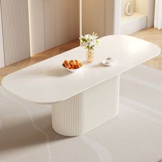 a white table sitting on top of a wooden floor next to a vase filled with flowers