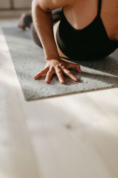 a woman is doing yoga on the floor