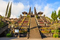 the stairs lead up to an elaborately designed building with flowers growing on it's sides