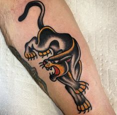 a man with a tattoo on his arm that has an image of a cat in it