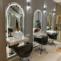 a salon with chairs and mirrors in it