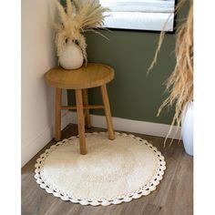 a small table with a potted plant sitting on top of it next to a window