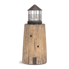 a wooden lighthouse with a light on top