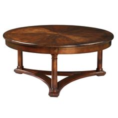 a round wooden table with an intricate design on the top and bottom, against a white background