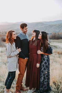 a group of people standing next to each other in a field