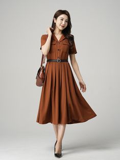 "This stunning brown shirt dress is a versatile piece that can be dressed up or down depending on the occasion. Featuring elegant pleats, this dress is perfect for both work and play. The short sleeves make it perfect for warmer weather, while the brown color gives it a classic look that will never go out of style. Pair it with heels for a sophisticated office look or sandals for a casual day out. DETAIL * The brown dress contain 50% polyester, others are nylon,fiber * Has no pockets * Right sid Brown Shirt Dress Outfit, Collared Solid Dresses With Pockets, Casual Brown A-line Midi Dress, Office Lady Style Dress With Button Closure For Spring, Fall Dresses With Button Closure For Office Wear, Single Breasted Midi Length Dresses, Single-breasted Solid Dress, Single-breasted Midi Dress, Office Lady Dresses With Buttons For Fall