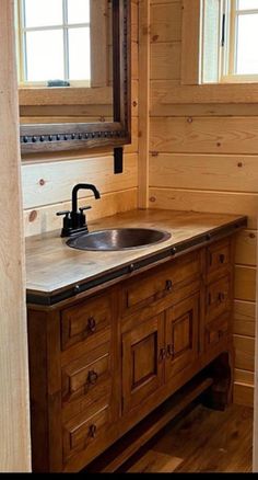 a bathroom with wood paneling and a sink