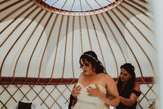 the bride is getting ready to walk down the aisle at her wedding ceremony in a yurt