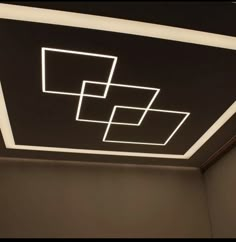 the ceiling is made up of square and rectangle shapes with white lights on them