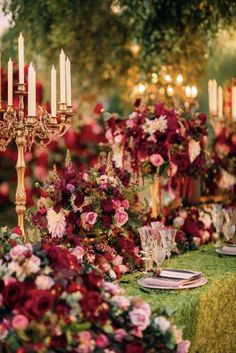 a table set with flowers and candles for an elegant dinner or wedding reception in the garden