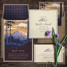 wedding stationery with mountain scene and purple flowers