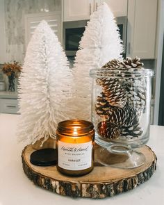 a candle and some pine cones on a table