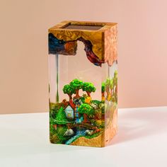 a glass vase with a painting on the inside of it, sitting on a table