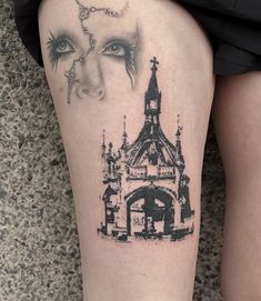 a woman's leg with a black and white drawing of a building on it