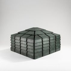 a stack of gray tiles sitting on top of a white table