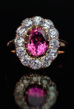 An Antique Diamond and Pink Tourmaline Cluster Ring circa 1900 The gold ring is centered with a purplish pink tourmaline (approximately 2 ct) framed by twelve old European cut diamonds (H-I color, VS1-SI1 clarity) with an estimated total weight of 2 carats. Bijoux Art Deco, Rings Antique, Pink Tourmaline Ring, Faberge Eggs, Tourmaline Jewelry, Ring Antique, Tourmaline Ring, Antique Diamond