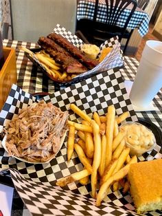 some food is sitting on a checkered table cloth and there are two plates with different foods