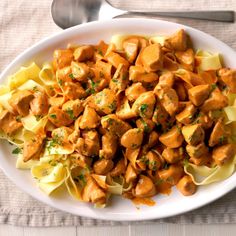 a white plate topped with pasta and chicken