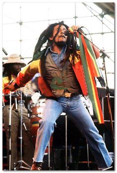 a man with dreadlocks standing on stage