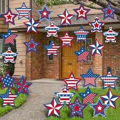 red, white and blue stars hanging from the side of a house