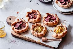 several small pies are on a cutting board