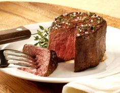 a piece of steak on a plate with a fork