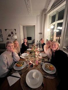 a group of people sitting around a dinner table