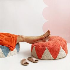 a woman laying on top of a bean bag chair with her feet propped up in the air