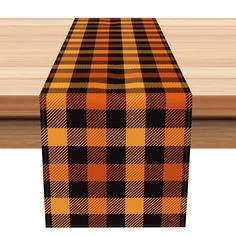 an orange and black plaid table runner