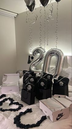 some balloons are hanging from the ceiling above a table with black and white items on it