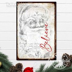 a christmas card with santa claus's face on it and pine cones in the foreground