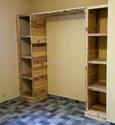 an empty room with wooden shelves and tiled floor