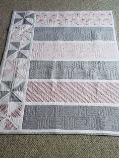 a close up of a quilt on the floor